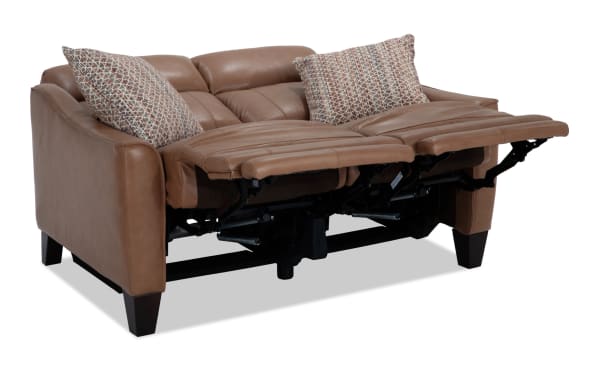 Empire Cognac leather 59'' power reclining loveseat with vinyl accents, power headrest, transitional style, and patterned accent pillows.