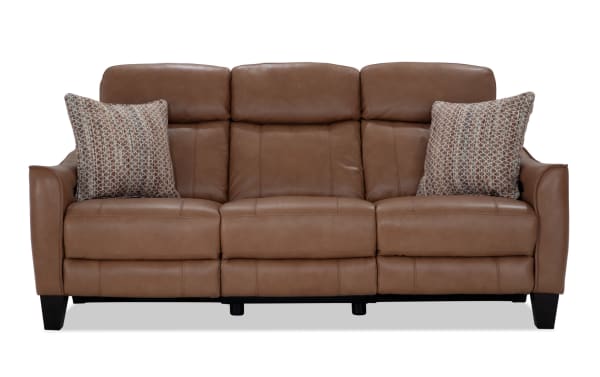 Empire Cognac leather 82-inch power reclining sofa with power headrest, transitional style, brown leather upholstery, and accent pillows.