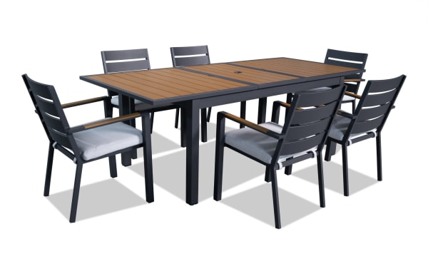 Laguna 7 Piece Gray Aluminum Outdoor Dining Set with powder-coated metal frame, polyester cushions, and extendable leaf for versatile patio dining.