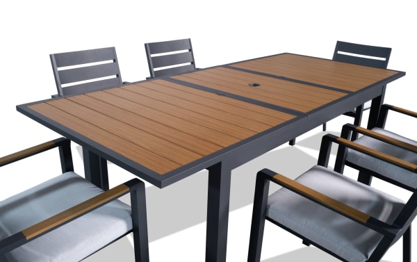 Contemporary Laguna 7 Piece Gray Aluminum Outdoor Dining Set with powder-coated metal frame, extendable table leaf, and gray polyester fabric cushions.