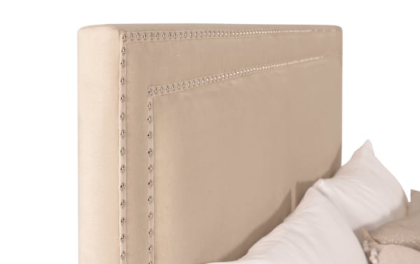 Beige Tremont Full Upholstered Panel Bed headboard with polished nailhead trim, polyester fabric, and rubberwood construction in transitional style.