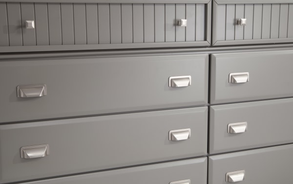 Spencer Gray 8-drawer dresser in transitional style with gray hardwood solids, MDF, plywood, and poplar construction, featuring sleek silver handles and ample storage.