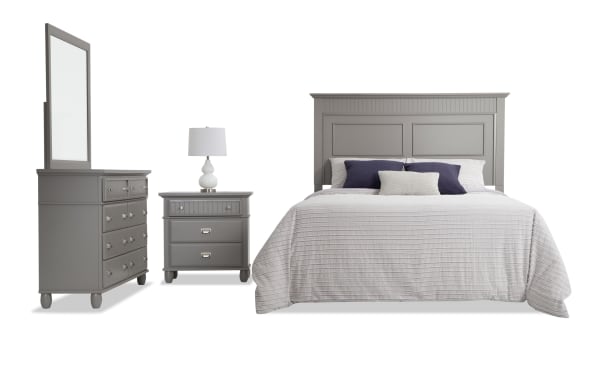 Spencer 4 Piece King Gray Panel Bedroom Set with hardwood solids, MDF, and veneers, featuring a large paneled headboard, dresser with mirror, and nightstand in transitional style.