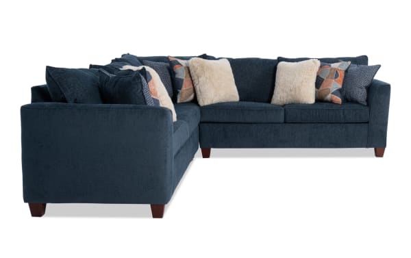 Brynn Navy 114'' 3 Piece Sectional in soft navy blue polyester fabric with Bob-O-Pedic Memory Foam cushions, transitional style, and assorted plush accent pillows.