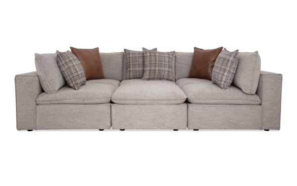 Infinity Gray 117'' 6-piece modular sectional with gray polyester fabric, transitional style, includes 3 armless chairs, 2 corners, 1 ottoman, and mixed fabric/feather accent pillows.