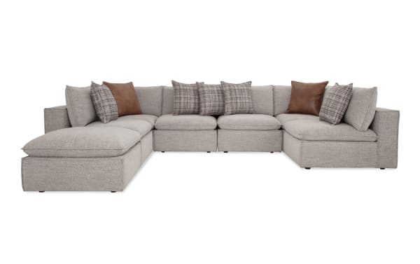 Infinity Gray 150'' 7-piece modular sectional in gray polyester fabric with 4 armless chairs, 2 corners, 1 ottoman, transitional style, Bob-O-Pedic® seats, feather-blend pillows, and Siberian pine frame.