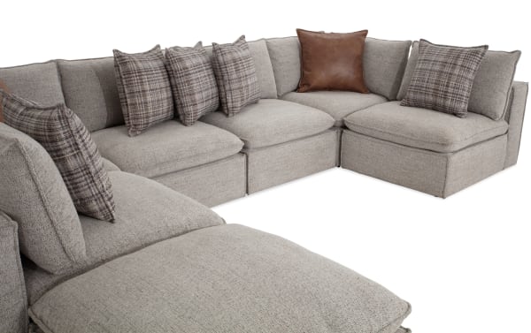 Infinity Gray 150'' 7-piece modular sectional with 4 armless chairs, 2 corners, 1 ottoman in gray polyester fabric. Transitional style with Bob-O-Pedic® stuffed seats, feather-blend accent pillows, removable back cushions, and a sturdy Siberian pine frame.