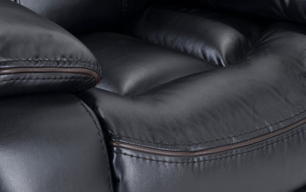 Close-up of the Avenger Black Power Recliner’s black faux leather upholstery with detailed stitching and plush Bob-O-Pedic memory foam cushioning for comfort.