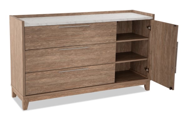 Solitude Light Brown 3 Drawer Dresser from Solitude Bedroom collection, featuring engineered wood grain, MDF, faux marble top, and metal handles. Contemporary style with three spacious drawers and a cabinet with adjustable shelves for versatile storage.