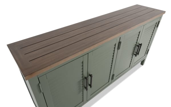 Sawyer Green 4 Door Cabinet in farmhouse style with rubberwood top, green MDF and plywood body, black handles, and adjustable shelves for versatile storage.