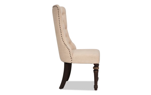 Regency Beige Solid Back Dining Chair with traditional tufted beige polyester fabric, nailhead trim, and carved hardwood legs from the Regency Dining collection.