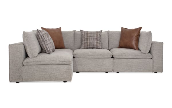 Infinity Gray 117" 4-piece modular sectional in gray polyester fabric with Bob-O-Pedic® seats, feather blend pillows, and Siberian pine frame.