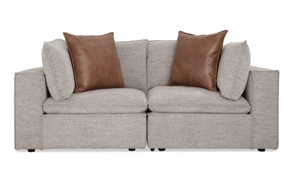 Infinity Gray 85'' 2-piece modular loveseat with gray polyester fabric upholstery, transitional style, wood frame, and brown accent pillows.