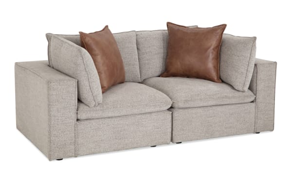 Gray Infinity 85'' 2-piece modular loveseat with transitional style, polyester fabric upholstery, Bob-O-Pedic® stuffed seats, feather-blend pillows, and sturdy Siberian pine frame.
