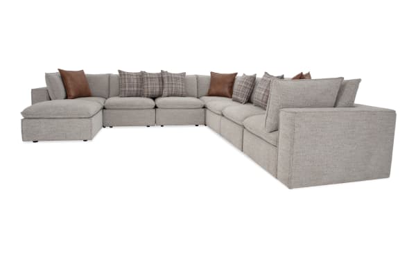 Infinity Gray 154" 8-piece modular sectional in gray polyester fabric with 4 armless chairs, 3 corners, 1 ottoman. Transitional style with Bob-O-Pedic® seats, feather-blend pillows, removable back cushions, and Siberian pine frame.