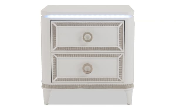 Glitz White 2 Drawer Nightstand in glam style with poplar solids, chrome hardware, mirrored crystal trim, and built-in LED lighting from Glitz Bedroom Collection.