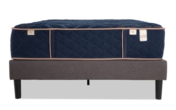 Copper Radiance 13'' King Dual Universal Mattress Set with navy quilted copper-infused cover, gel layers, and gray fabric foundation with black legs.