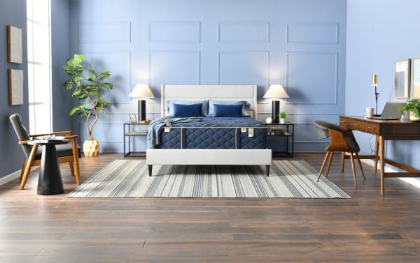 Copper Radiance 14.5'' Queen Plush Universal Mattress Set with copper-infused gel cover, plush hybrid design, and Bob-O-Pedic memory foam in a modern blue bedroom setting.