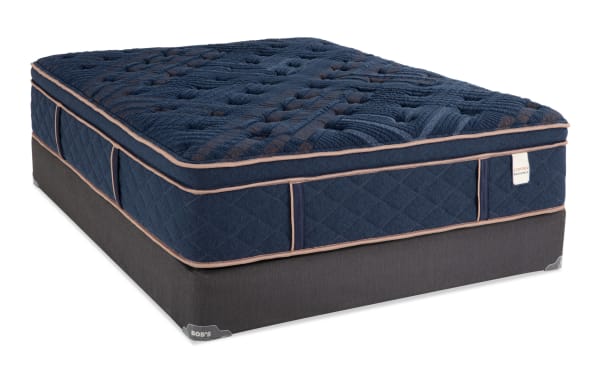 Copper Radiance 14.5'' Twin XL plush hybrid mattress set with navy quilted copper-infused cover, gel layers, wrapped coils, and dark gray foundation by Bob's.