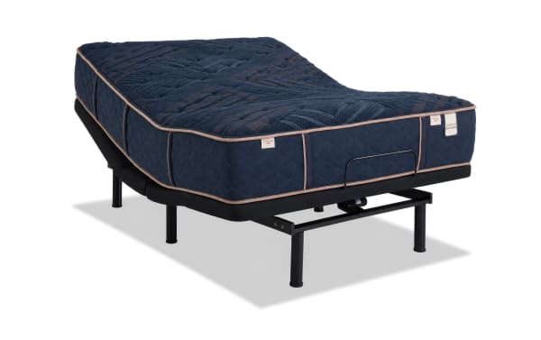 Power Bob Elite Base with Copper Radiance 13'' Queen Dual Mattress set in a modern bedroom, featuring a copper-infused gel memory foam mattress with navy blue quilted cover, adjustable white upholstered base, and dual comfort design from Copper Radiance collection.