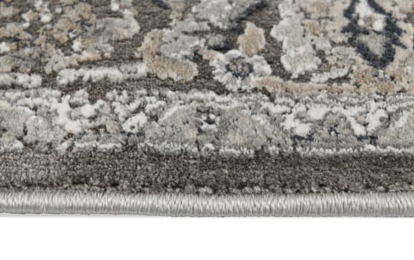Close-up of the Amelia 8' x 10' Brown Oriental Rug showing its plush polyester fabric, transitional style, and intricate vintage-inspired brown pattern with detailed edging.