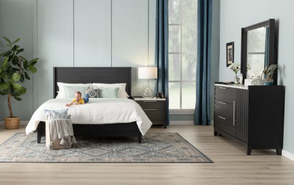 Contemporary Solitude Full Espresso Platform Bed with slatted MDF headboard, adjustable legs, dark wood grain finish, paired with matching nightstand and dresser.