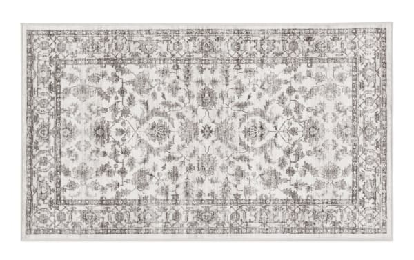 Cream Ivy 2' x 4' washable rug with vintage-inspired oriental pattern, low pile polyester fabric, and transitional beige tones for durable home decor.