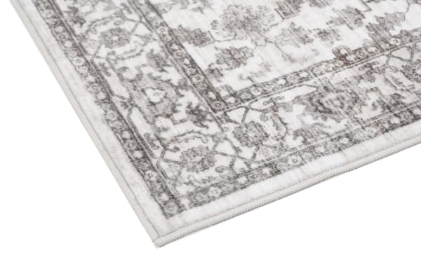 Cream Ivy 2' x 4' transitional oriental rug with vintage-inspired pattern, low pile, and durable washable polyester fabric for easy cleaning.