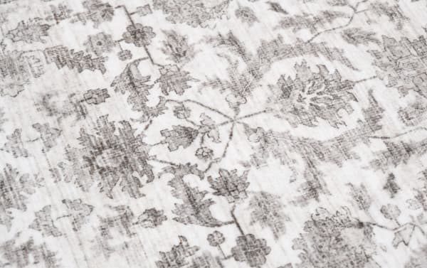 Cream Ivy 2' x 4' washable rug with vintage-inspired oriental pattern, low pile polyester fabric, and transitional beige tones for durable home decor.