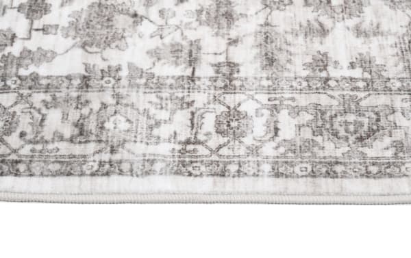 Cream Ivy 2' x 4' transitional washable rug with vintage-inspired oriental pattern, low pile polyester fabric, durable for kids and pets.