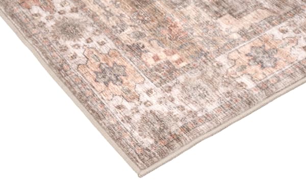 Corner close-up of Monarch 3' x 6' Red Oriental washable runner with vintage-inspired red and beige floral pattern, low pile polyester fabric.