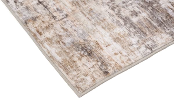 Wells 5' x 7' brown abstract washable rug with low pile, transitional style, and durable polyester fabric for easy cleaning and high traffic areas.