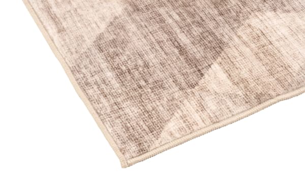 Brown abstract patterned Wells 3' x 6' washable runner with low pile polyester fabric, featuring a transitional style and durable construction.