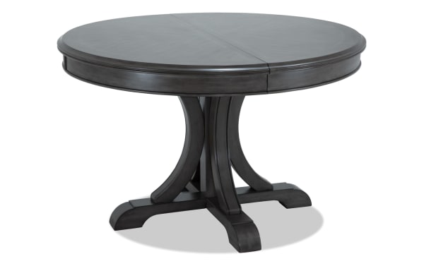 Coco II Gray Oval Extendable Dining Table from Coco collection, made of Asian hardwood solids and cherry veneers, features a contemporary gray finish and a central pedestal base.