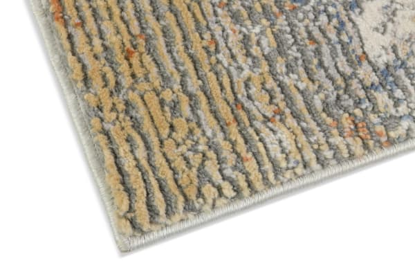Corner close-up of Aurora 8' x 10' Cream & Light Gray Abstract Rug with low pile polyester fabric, featuring a multicolored abstract pattern ideal for high-traffic areas.