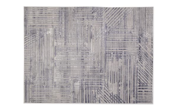 Linea 5' x 7' cream and charcoal abstract shag rug with geometric pattern, soft polyester fabric, adds modern style and texture to home decor.