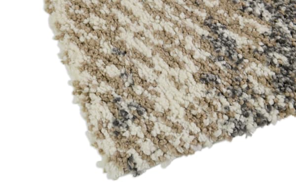 Corner close-up of the Oliver 5' x 7' white and gray striped shag rug, featuring soft polyester fabric with a multicolored textured pattern.