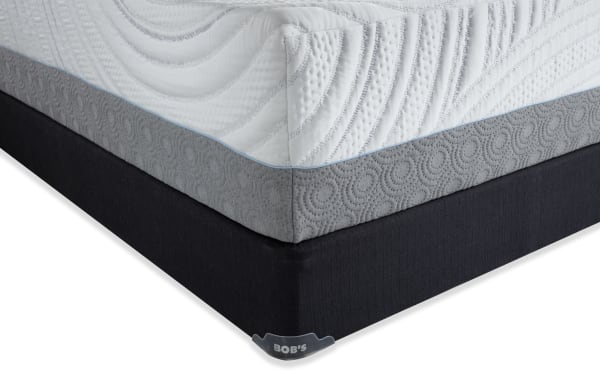 Corner view of Bob's Twilight 15.5'' Twin XL Firm Standard Mattress Set with white quilted top, gray patterned side panel, and black foundation base.