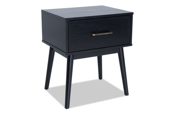 Bettie Black Storage End Table in mid-century modern style, made of black wood with tapered legs and a single drawer with brass handle.