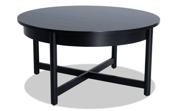 Bettie Black Round Coffee Table in mid-century modern style, made of black wood with an espresso finish, featuring a space-saving round top and crossbar legs.