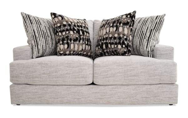 Glacier White 70'' transitional loveseat with plush white polyester fabric, Bob-O-Pedic memory foam cushions, and four patterned accent pillows.