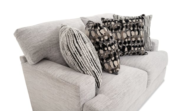 Glacier White 70'' transitional loveseat in plush white polyester fabric with Bob-O-Pedic memory foam cushions and four patterned accent pillows.
