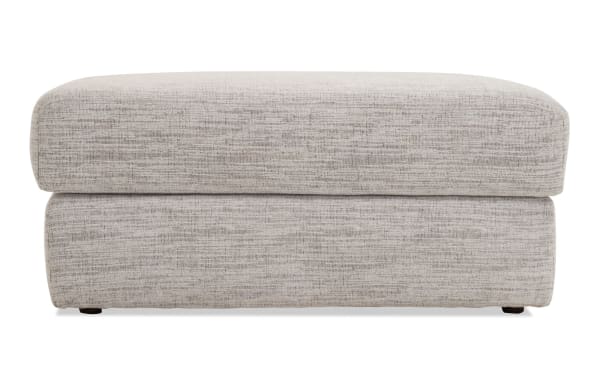 Glacier White Ottoman in transitional style with plush white polyester fabric and memory foam cushion, ideal for seating or footrest.