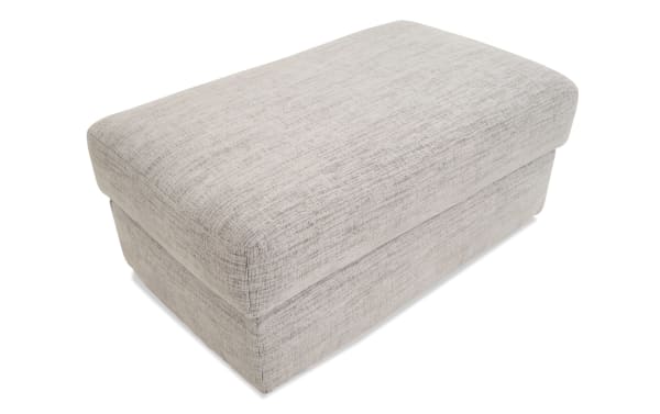 Glacier White Ottoman in transitional style with plush white polyester fabric upholstery and memory foam cushion for seating or footrest.