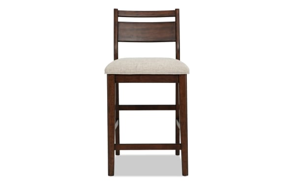 Contemporary Mango Dining panel back counter height stool in beige polyester fabric with solid mango wood frame and memory foam seat cushion.