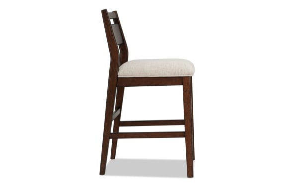 Contemporary Mango Dining counter height stool with beige polyester fabric seat, solid mango wood frame, and panel back design.