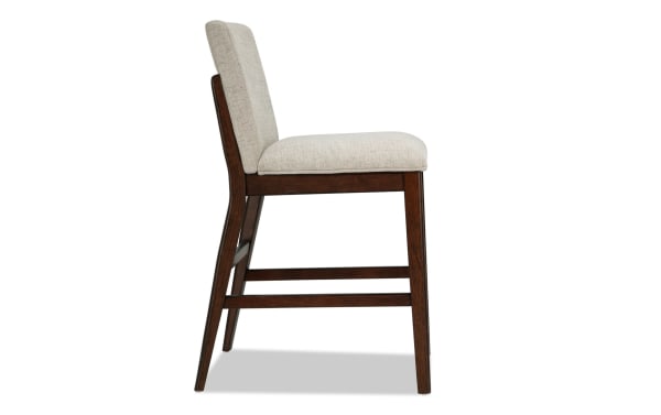 Contemporary Mango Brown & Beige solid mango wood counter height stool with beige polyester fabric upholstery and memory foam seat.