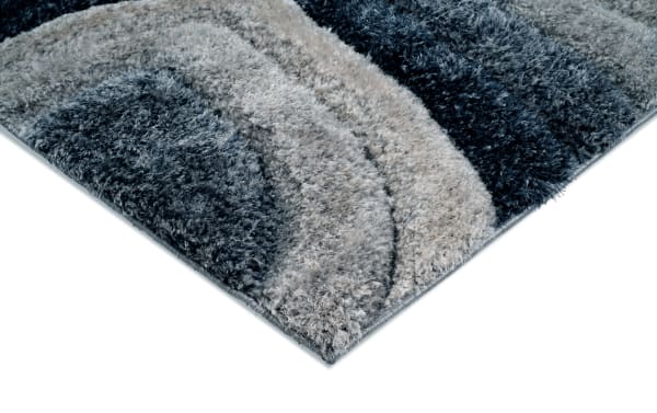 Contemporary Swirls 8' x 10' Blue Abstract Rug with plush medium pile polyester fabric in blue and gray tones, featuring curved swirl patterns.