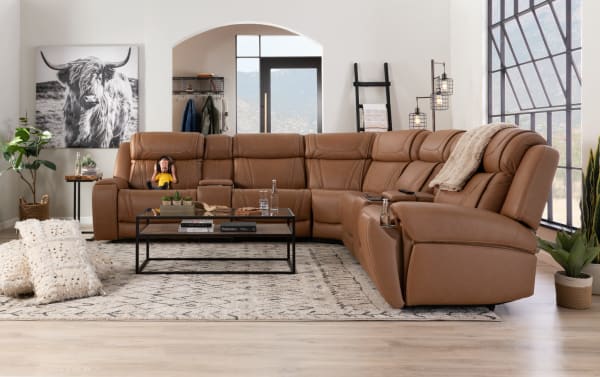 Dynamic Cognac leather 136" Bluetooth audio power reclining sectional sofa with armless chair, cupholders, storage console, and USB charging ports.