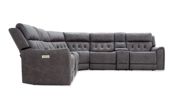 Gray sectional reclining sofa with plush cushioned backrests, tufted upholstery, and built-in control panel for adjustable comfort.